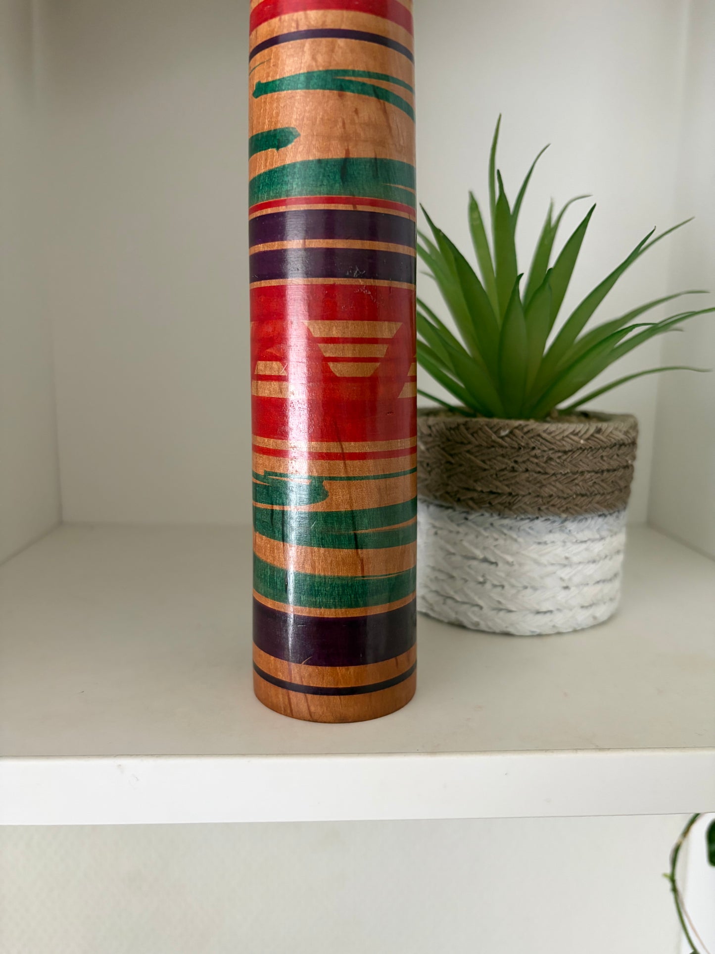 Vintage traditional Tsuchiyu kokeshi with striped design.